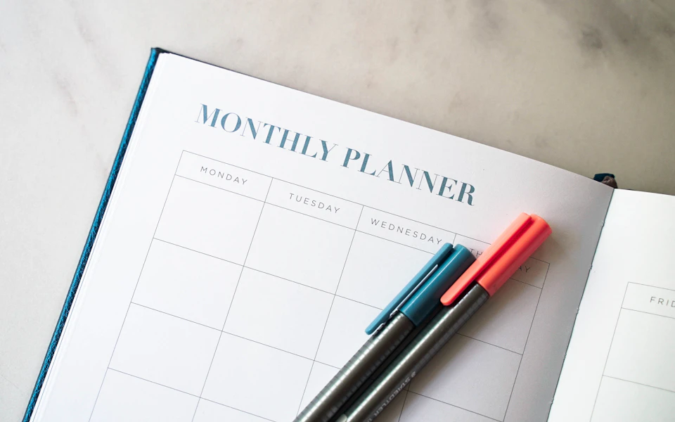 An open planner with pens ready to map out priorities